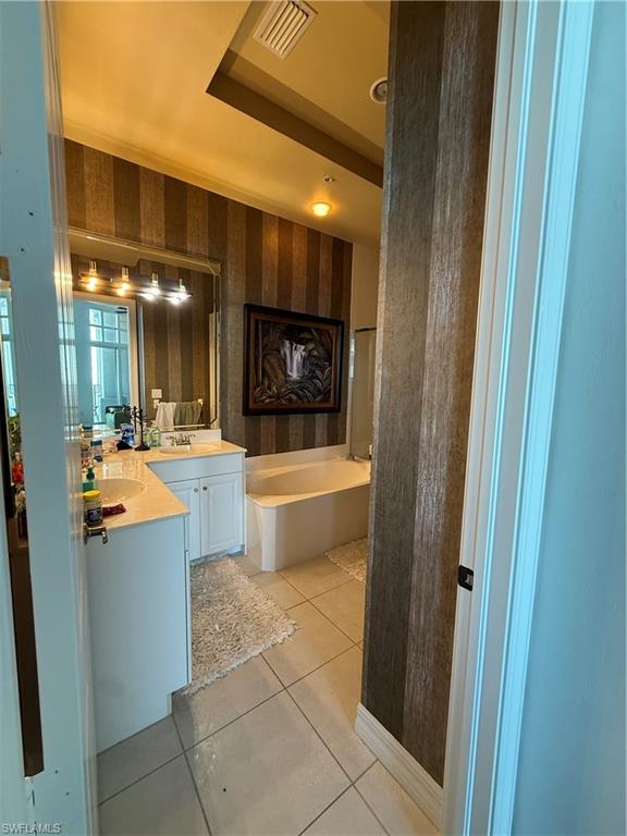 2797 First Street, Unit 2105 Fort Myers, FL 33916 - Photo 7 of 18 Full bathroom featuring wallpapered walls, a bath, double vanity, and light tile patterned floors