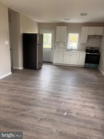 a view of a kitchen with a sink and a stove top oven