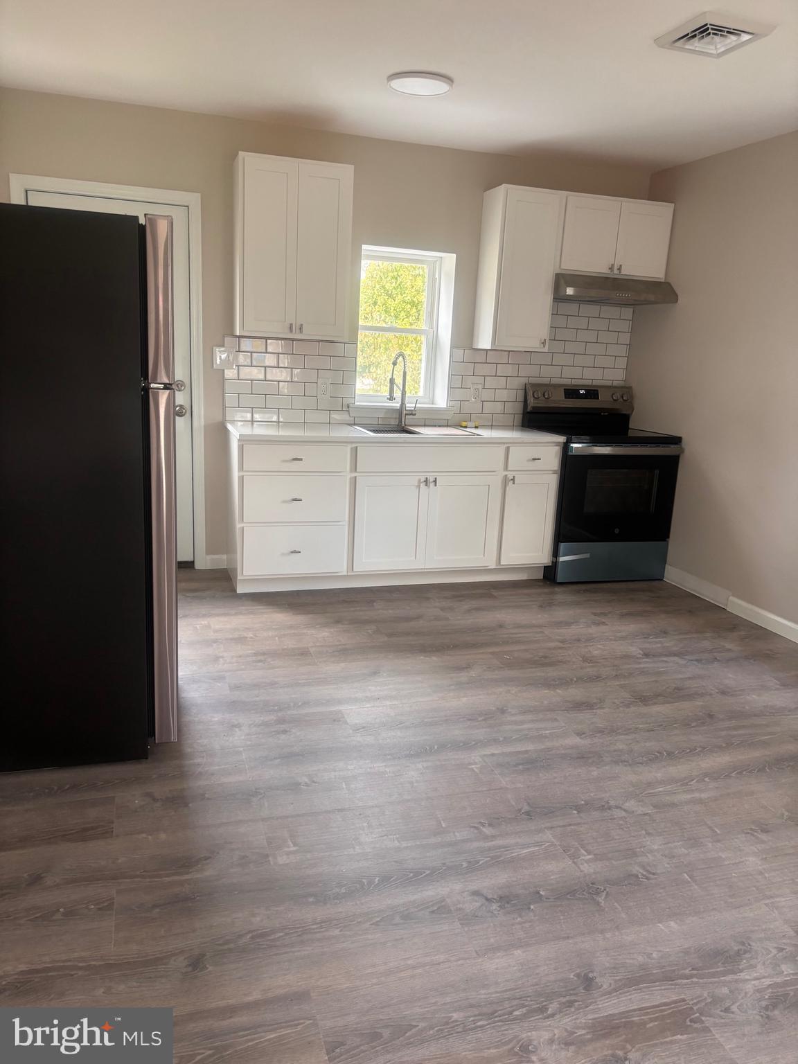 113 1/2 North Hook Road Pennsville, NJ 08070 - Photo 3 of 11 a kitchen with stainless steel appliances granite countertop a refrigerator and a stove