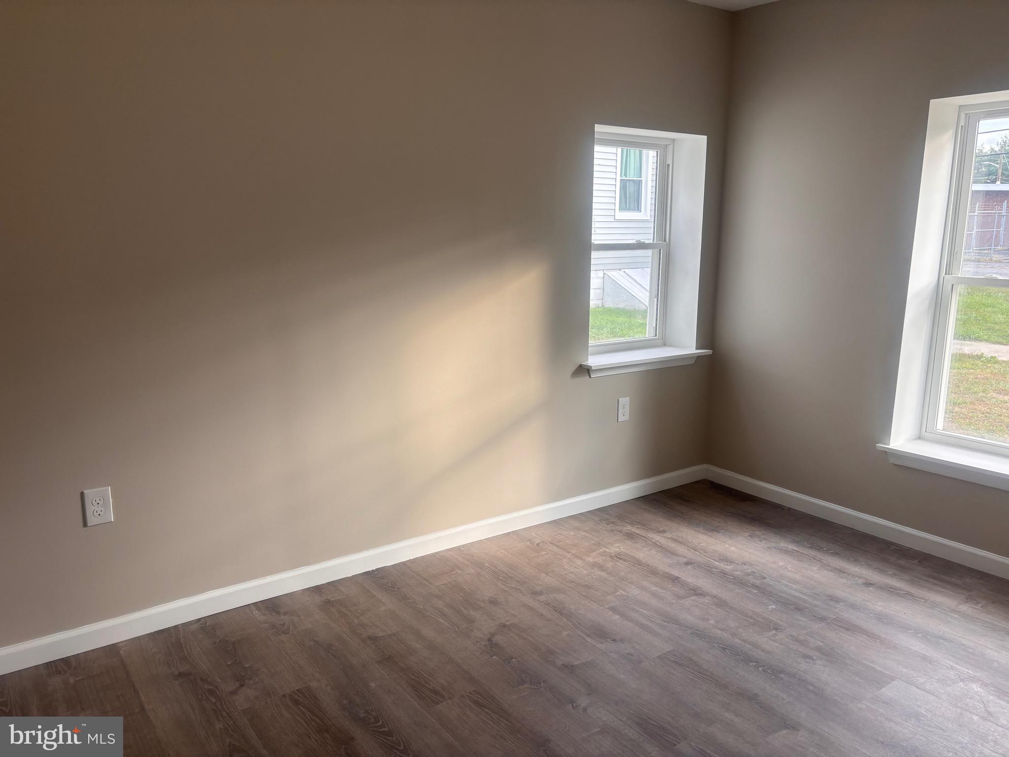 113 1/2 North Hook Road Pennsville, NJ 08070 - Photo 8 of 11 an empty room with wooden floor and windows