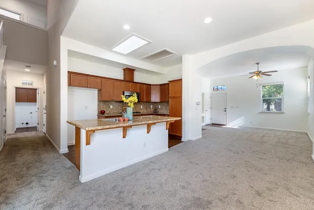 a view of kitchen with kitchen island and living room