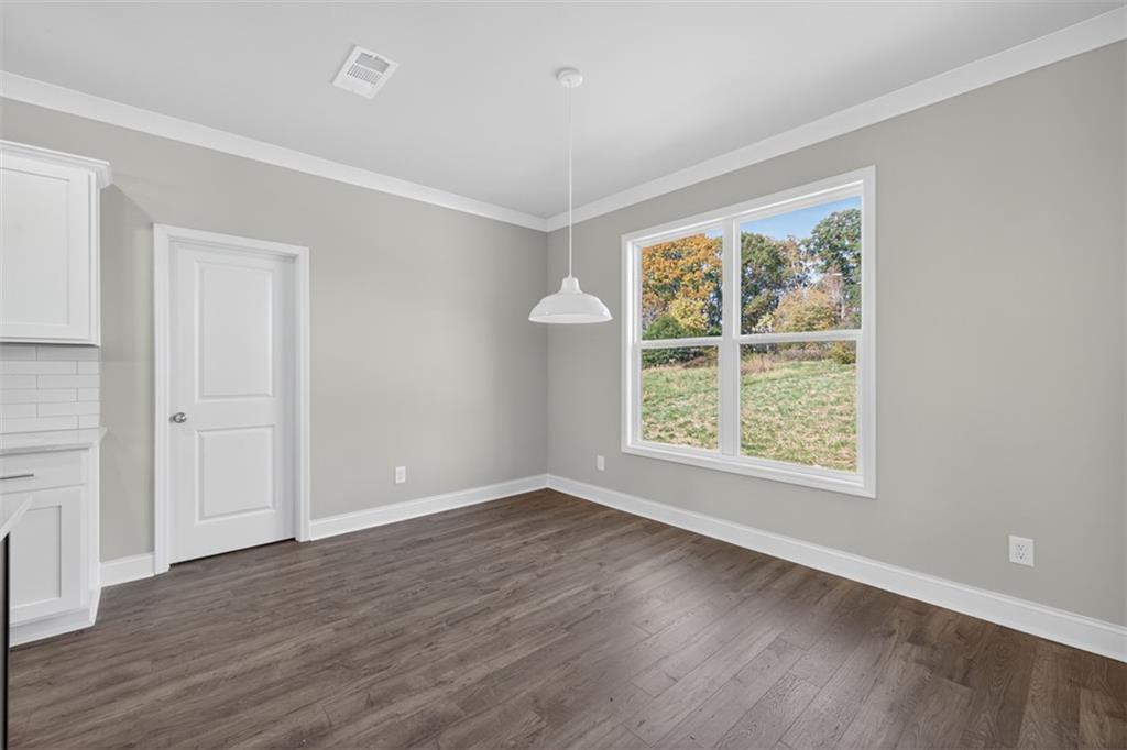 8845 Jot Em Down Road Gainesville, GA 30506 - Photo 24 of 87 an empty room with wooden floor and windows