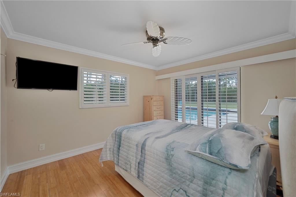 6440 Sable Ridge Lane Naples, FL 34109 - Photo 11 of 20 Bedroom with hardwood / wood-style floors, access to outside, crown molding, and ceiling fan