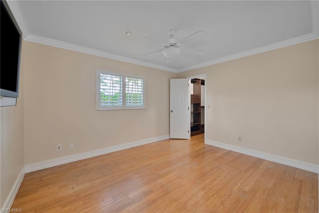 6440 Sable Ridge Lane Naples, FL 34109 - Photo 13 of 20 Spare room featuring light wood-style floors, ornamental molding, and a ceiling fan