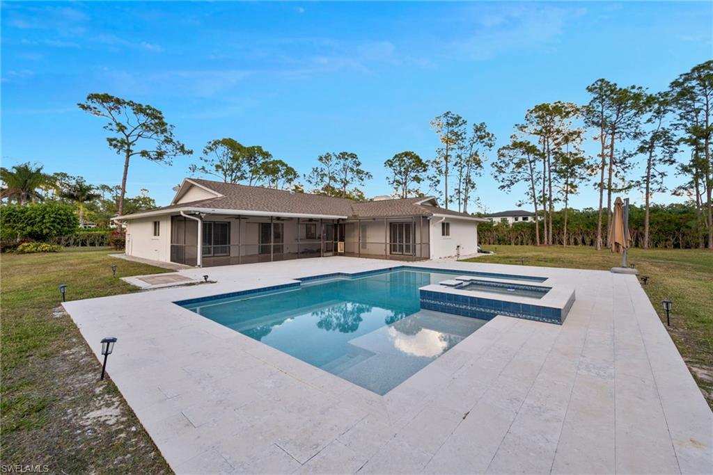 6440 Sable Ridge Lane Naples, FL 34109 - Photo 18 of 20 View of swimming pool with a sunroom, a lawn, a patio area, and a pool with connected hot tub