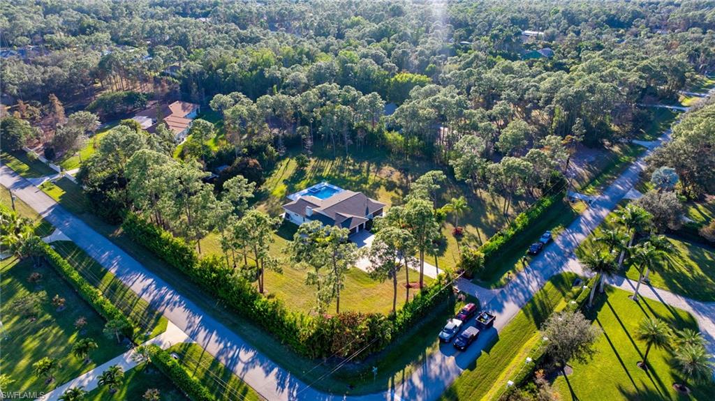 6440 Sable Ridge Lane Naples, FL 34109 - Photo 19 of 20 Aerial view of property and surrounding area with a forest