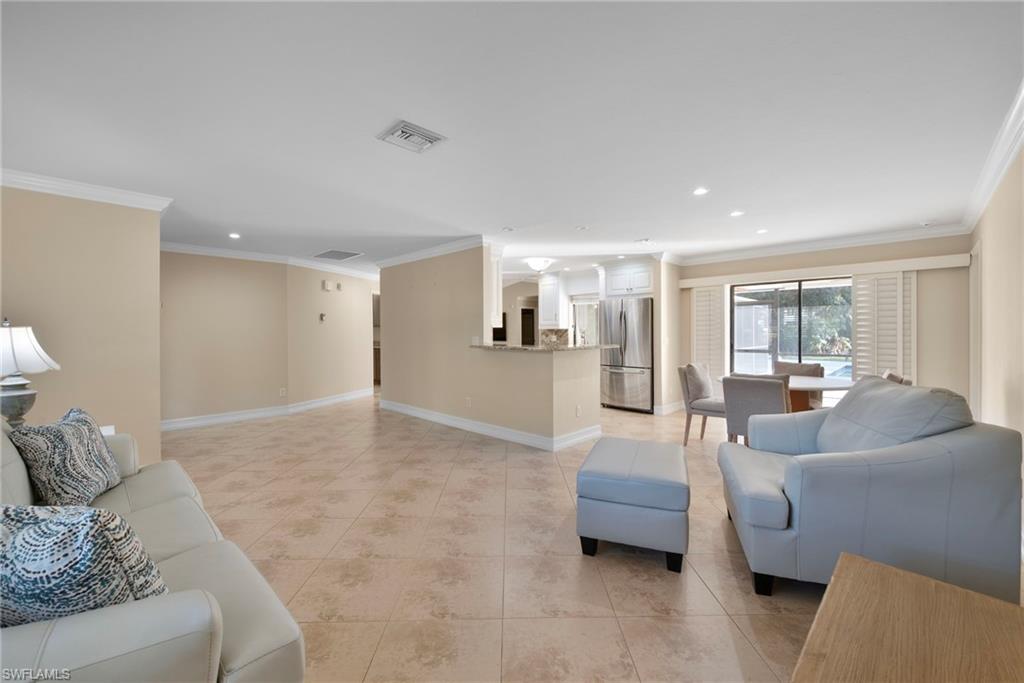 6440 Sable Ridge Lane Naples, FL 34109 - Photo 3 of 20 Living room with ornamental molding, recessed lighting, and light tile patterned floors