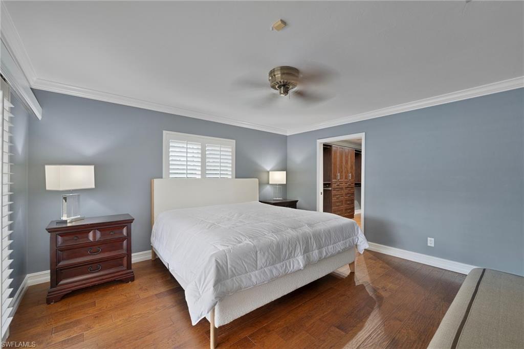 6440 Sable Ridge Lane Naples, FL 34109 - Photo 8 of 20 Bedroom with crown molding, hardwood / wood-style floors, a closet, and a ceiling fan