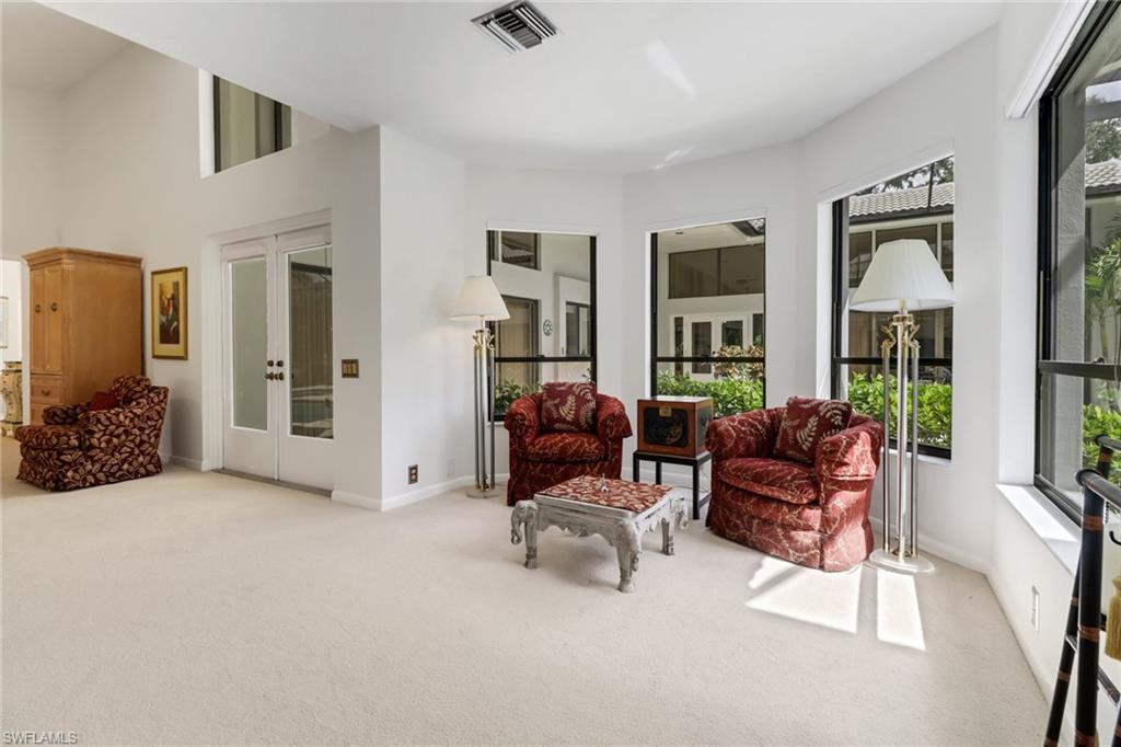 12902 Valewood Drive Naples, FL 34119 - Photo 12 of 22 a living room with furniture and a flat screen tv