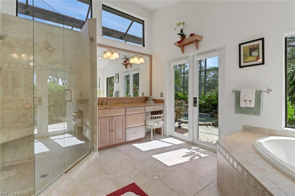 12902 Valewood Drive Naples, FL 34119 - Photo 14 of 22 a spacious bathroom with a granite countertop sink mirror and shower