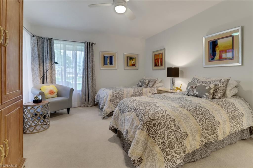 12902 Valewood Drive Naples, FL 34119 - Photo 15 of 22 a bedroom with bed couch and window