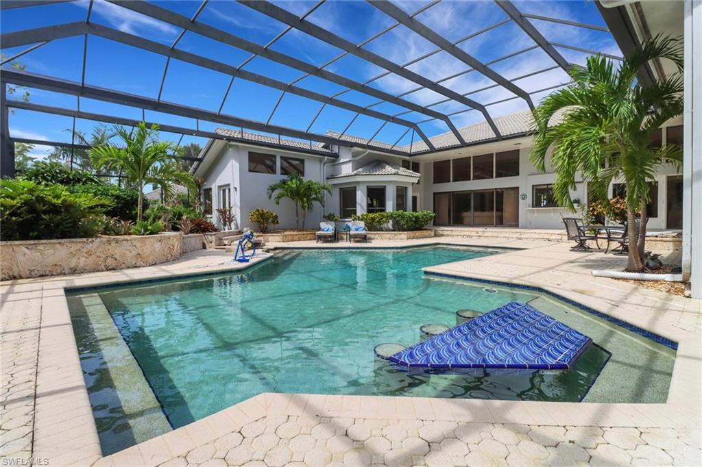 12902 Valewood Drive Naples, FL 34119 - Photo 18 of 22 a view of a backyard with plants and patio