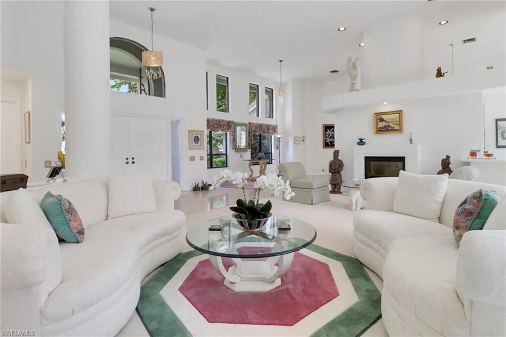 12902 Valewood Drive Naples, FL 34119 - Photo 2 of 22 a living room with furniture and a fireplace