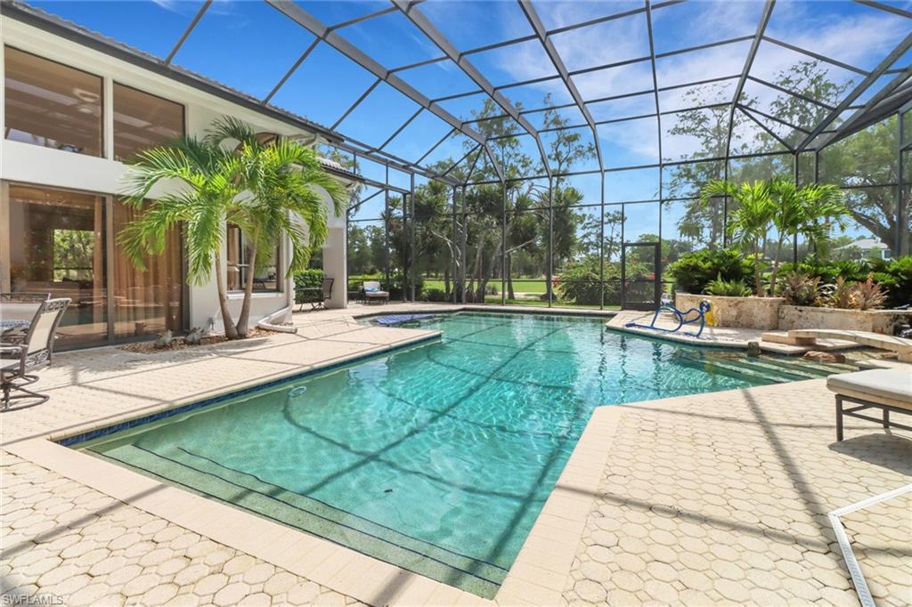 12902 Valewood Drive Naples, FL 34119 - Photo 21 of 22 a view of a swimming pool with a patio
