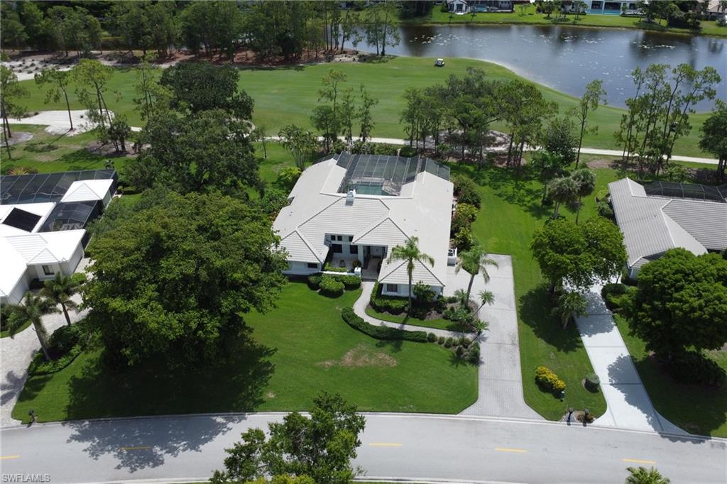 12902 Valewood Drive Naples, FL 34119 - Photo 22 of 22 an aerial view of a house with a yard and lake view