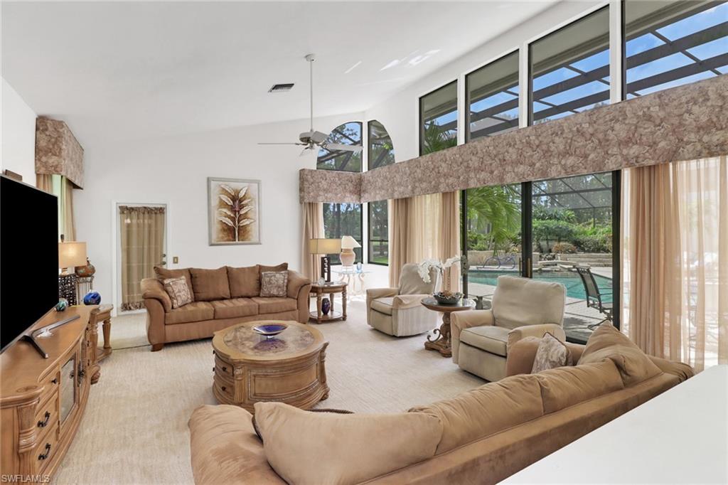 12902 Valewood Drive Naples, FL 34119 - Photo 7 of 22 a living room with furniture and a flat screen tv