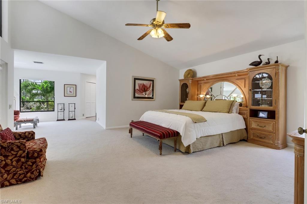 12902 Valewood Drive Naples, FL 34119 - Photo 10 of 22 a bed room with a bed and a couch