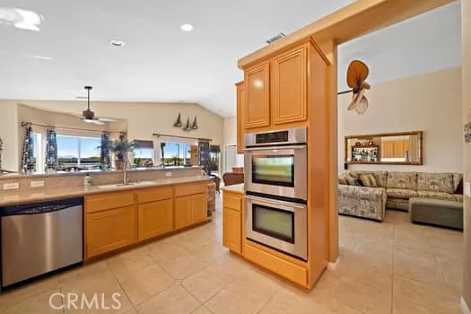 a kitchen with stainless steel appliances granite countertop a stove a refrigerator and a microwave