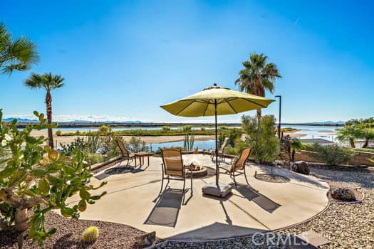 2710 Colorado River Road Blythe, CA 92225 - Photo 32 of 38 a view of a swimming pool with a table and chairs under an umbrella
