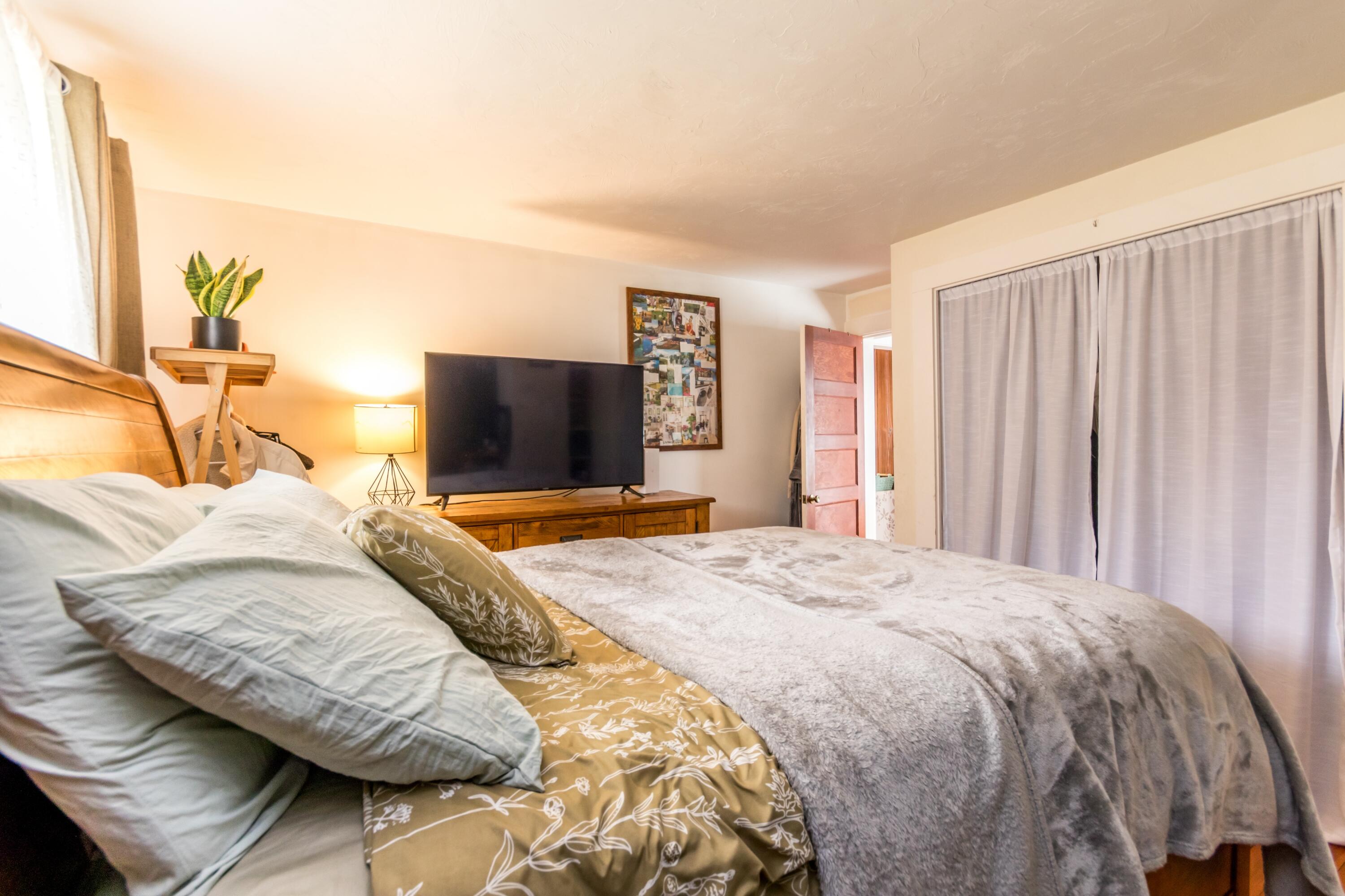 1003 Point Road Marion, MA 02738 - Photo 15 of 30 a bedroom with a large bed and a flat tv screen