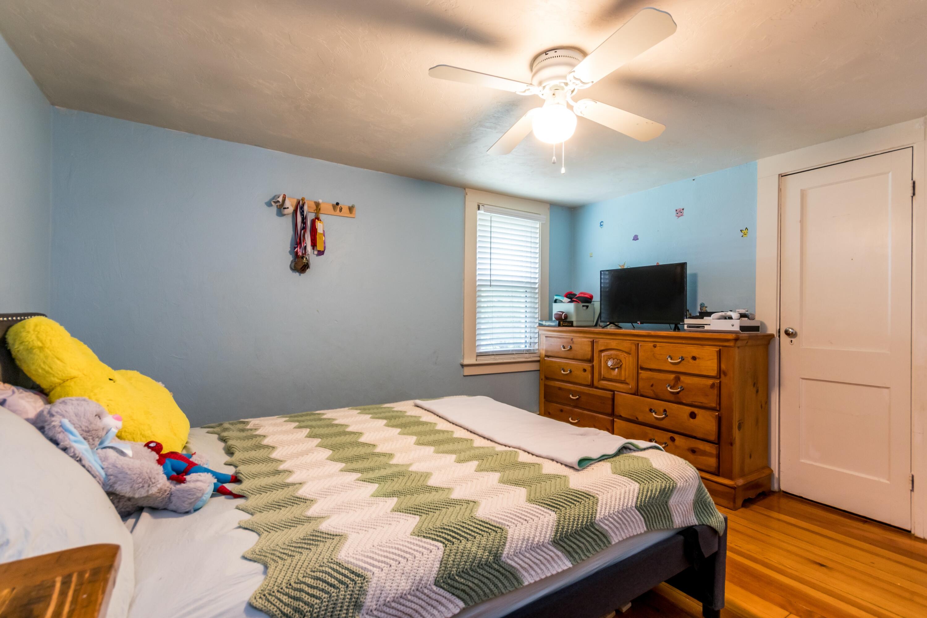 1003 Point Road Marion, MA 02738 - Photo 17 of 30 a bedroom with a bed and wooden floor