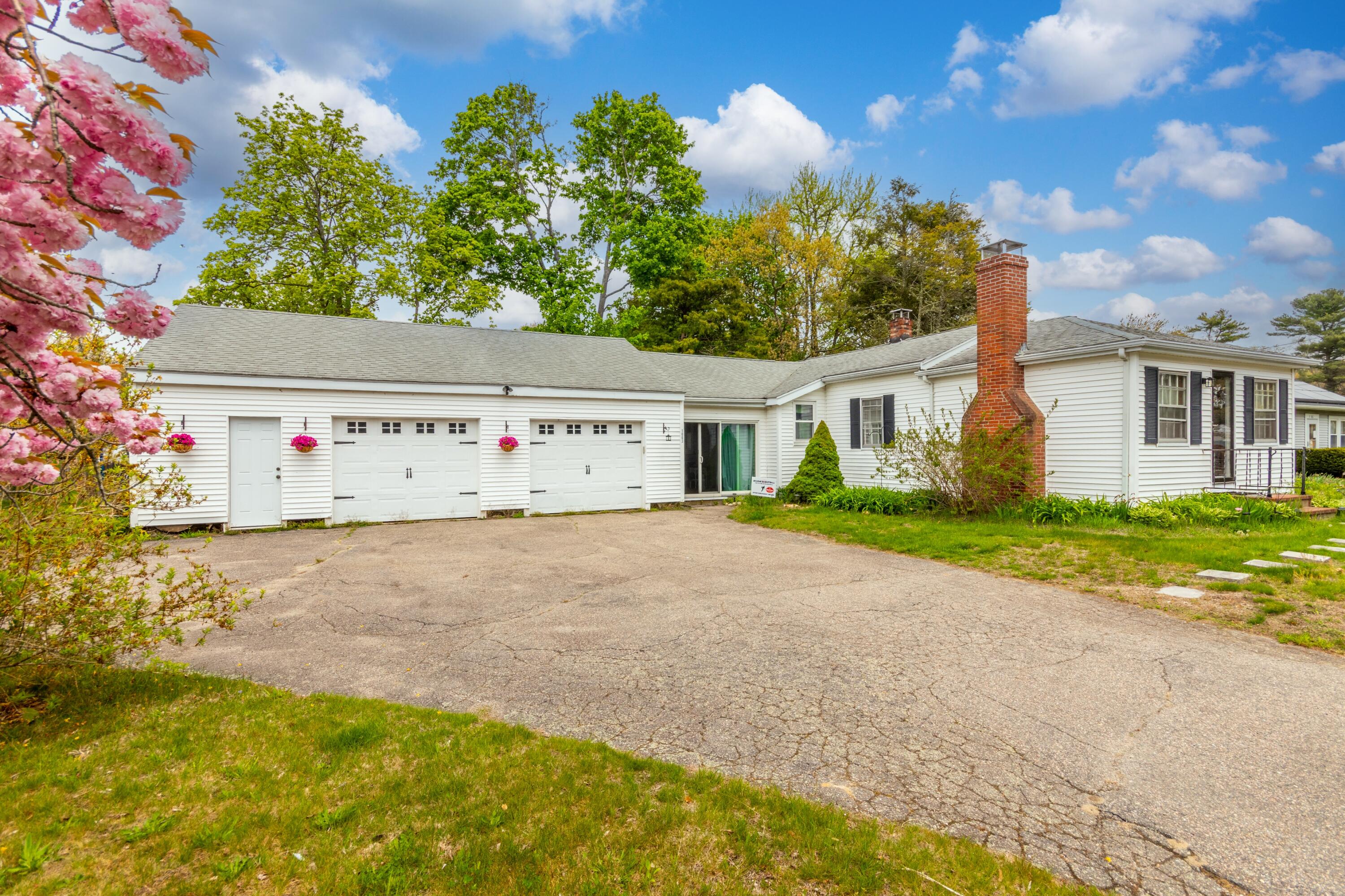1003 Point Road Marion, MA 02738 - Photo 24 of 30 a view of a white house with a yard and a garage