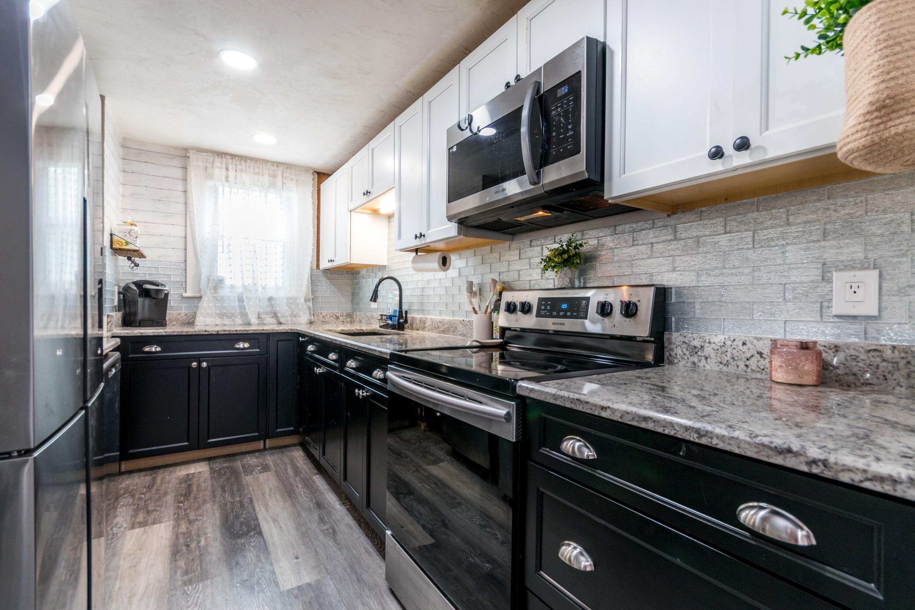 1003 Point Road Marion, MA 02738 - Photo 9 of 30 a kitchen with stainless steel appliances granite countertop a sink a stove and cabinets