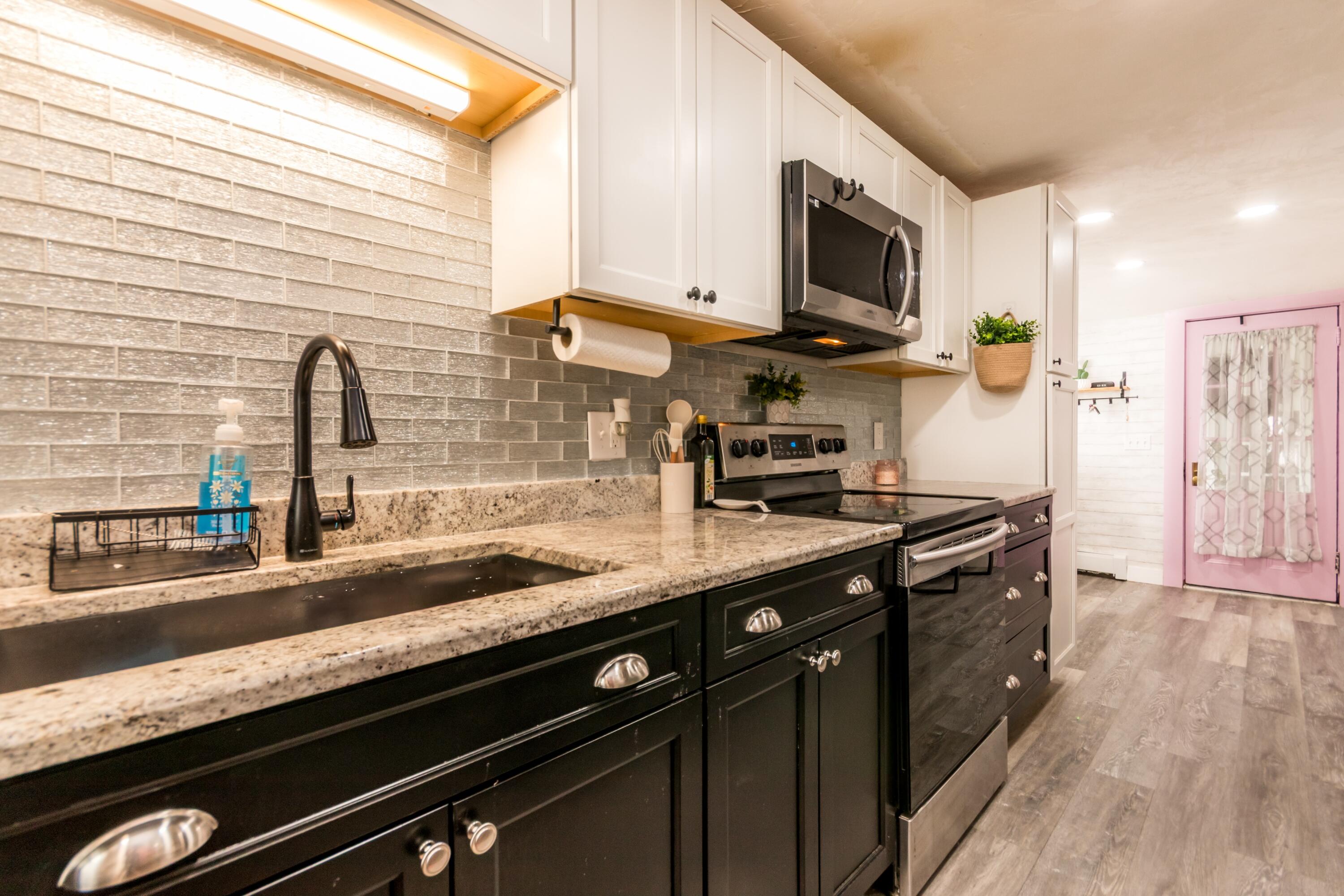 1003 Point Road Marion, MA 02738 - Photo 10 of 30 a kitchen with stainless steel appliances granite countertop a sink a stove and a wooden cabinets
