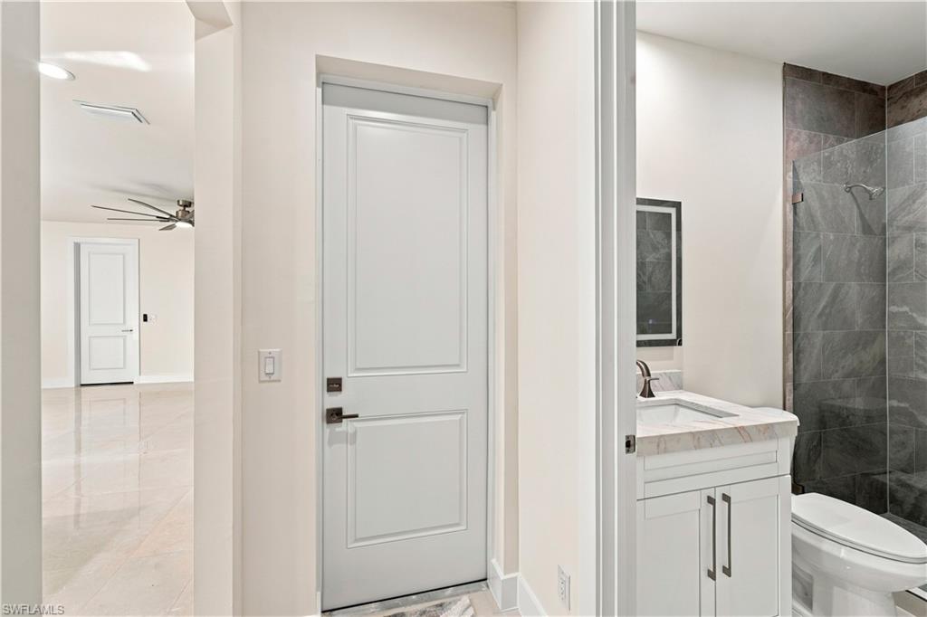 183 5th Street Southwest Naples, FL 34117 - Photo 21 of 40 White paneled interior doors with dark bronze hardware