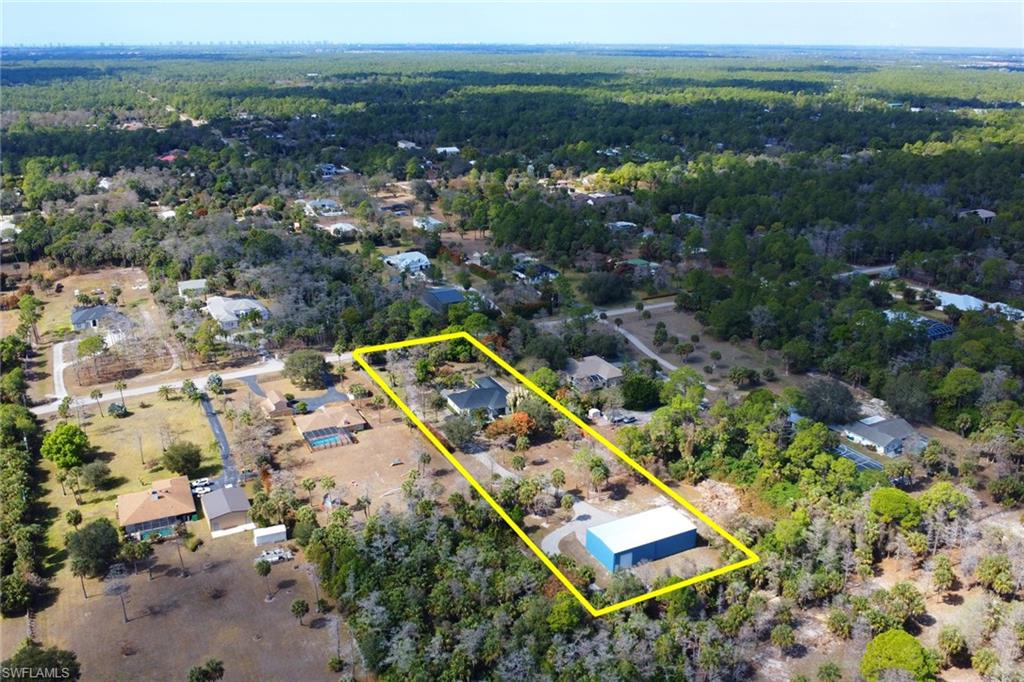 730 29th Street Southwest Naples, FL 34117 - Photo 48 of 50 Aerial view of property's location featuring property parcel outlined and a forest
