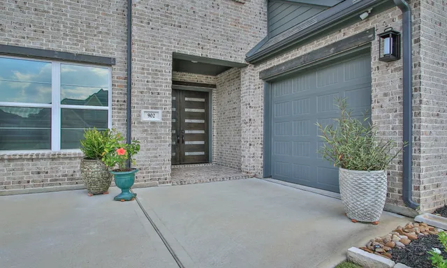 a bathroom with a glass door shower and a sink