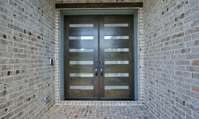 a hallway with wooden floor windows and stairs