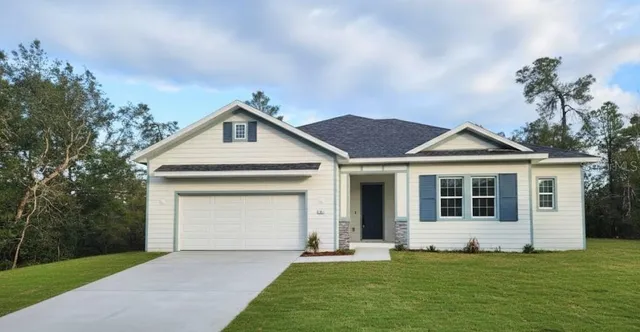 a front view of a house with a garden and yard