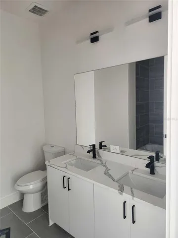 a bathroom with a sink toilet and mirror
