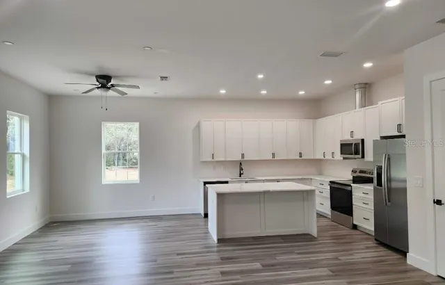 a view of kitchen with wooden floor and window