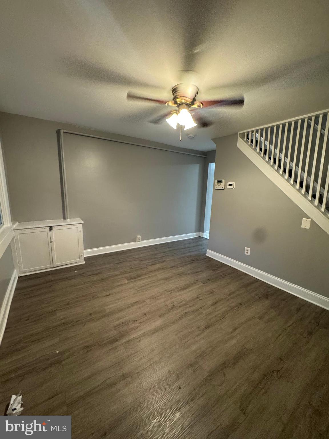 2705 Round Road Baltimore, MD 21225 - Photo 3 of 10 an empty room with wooden floor fan and windows