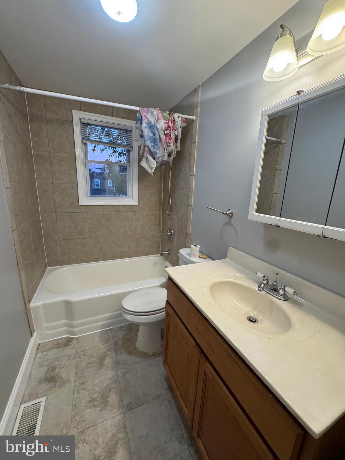 2705 Round Road Baltimore, MD 21225 - Photo 7 of 10 a bathroom with a sink a toilet and shower