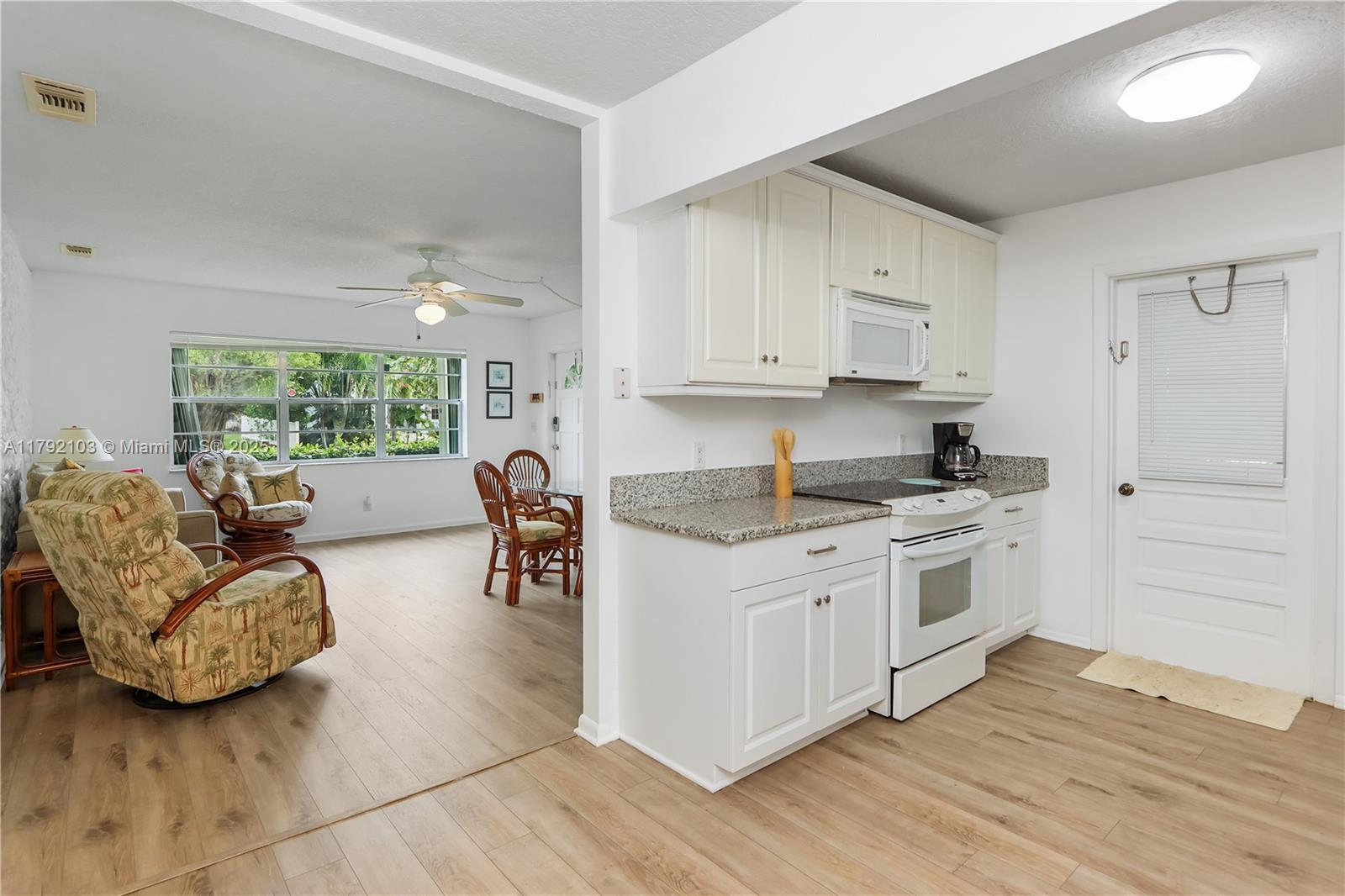 1115 Hernando Street Fort Pierce, FL 34949 - Photo 12 of 24 a kitchen with granite countertop a stove a sink and a refrigerator