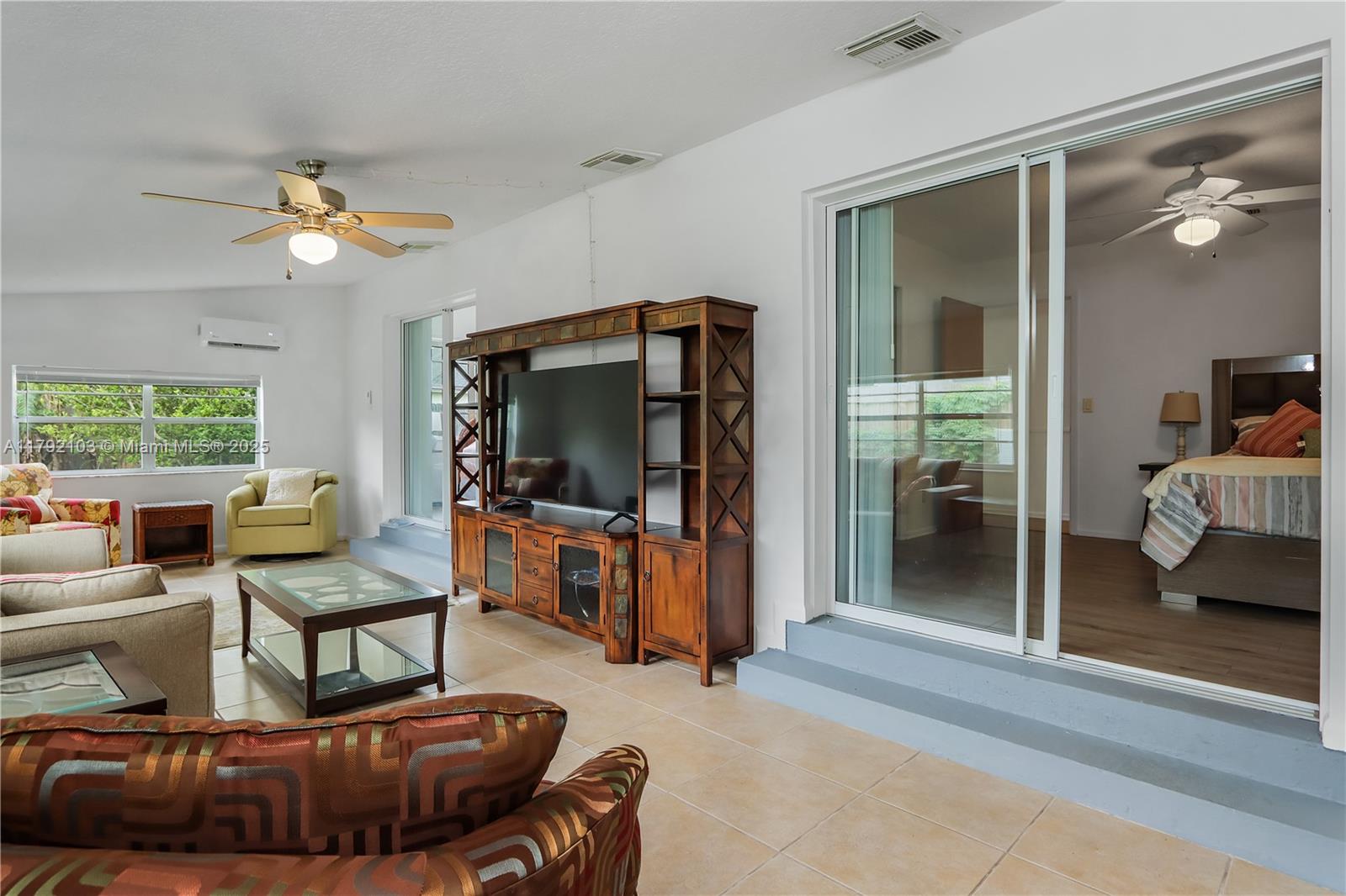 1115 Hernando Street Fort Pierce, FL 34949 - Photo 18 of 24 a living room with furniture and a flat screen tv