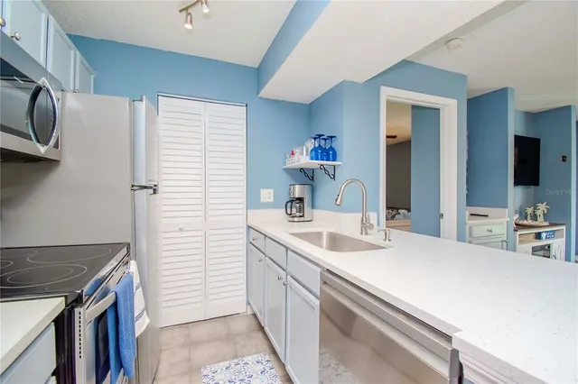 a kitchen with a sink and cabinets