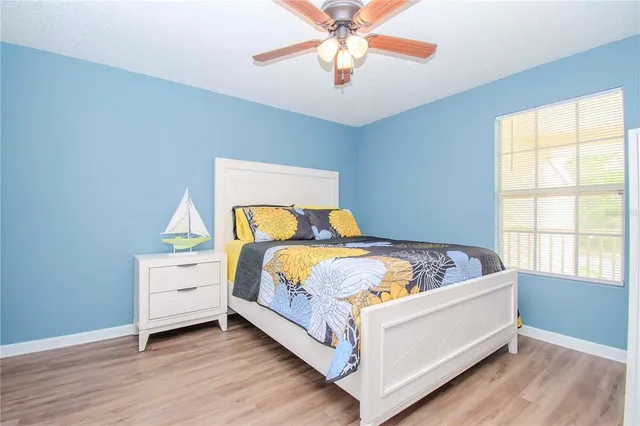 a bed sitting in a bedroom next to a window