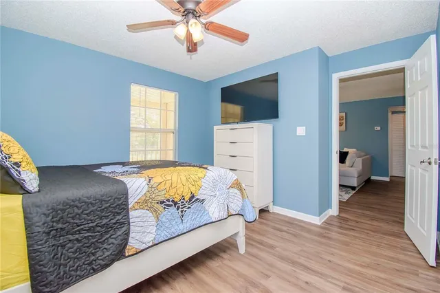 a bedroom with a bed and wooden floor
