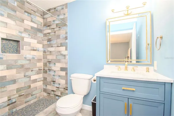 a bathroom with a sink a toilet and a mirror