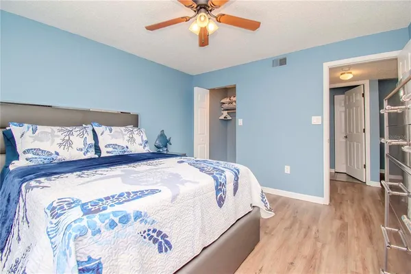 a bed sitting in a bedroom and chandelier