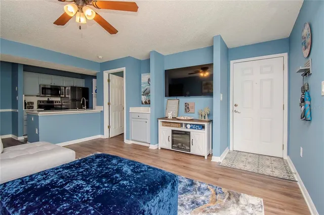 a living room with a flat screen tv and a fireplace