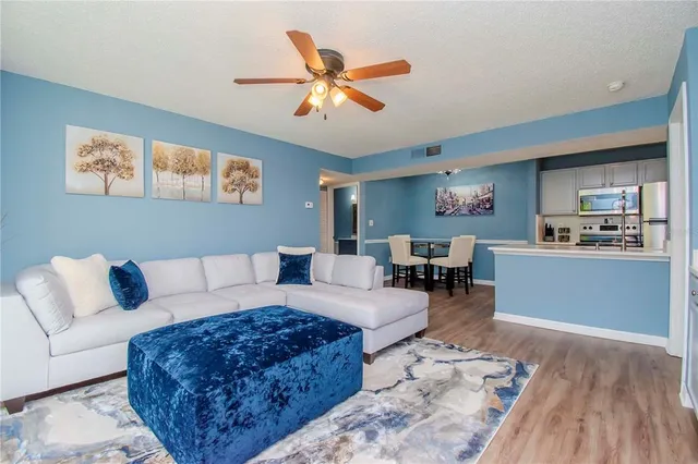 a living room with furniture and kitchen view