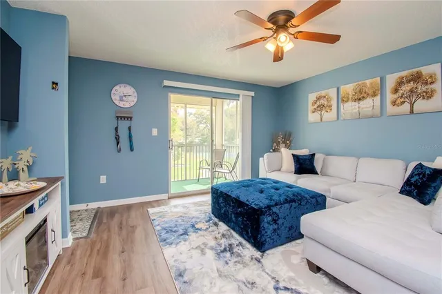 a living room with a bed furniture and a large window