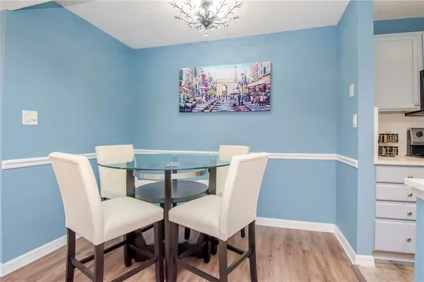 a view of a dining room with furniture and wooden floor