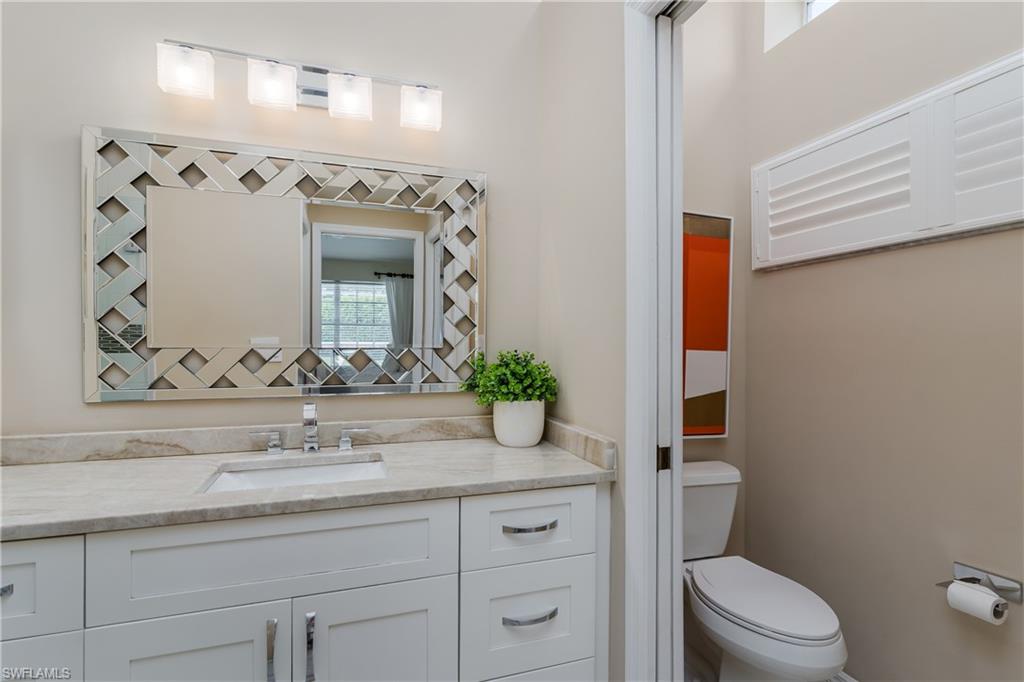 6658 Castlelawn Place, Unit 9 Naples, FL 34113 - Photo 19 of 38 Vaulted ceiling with a tropical-style ceiling fan, large window with horizontal blinds, and pool view