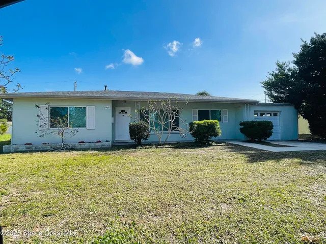 a view of a house with swimming pool and furniture